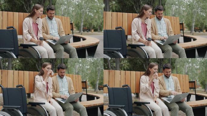 残疾男女在公园里用笔记本电脑喝酒去户外喝咖啡