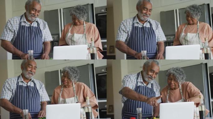 快乐的非洲裔美国老年夫妇一起做饭的动画，使用笔记本电脑
