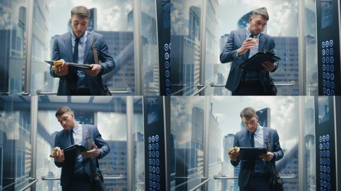 业务经理上班迟到，在现代办公楼里骑玻璃电梯。英俊的男人在乘电梯去公司会议的路上匆匆忙忙地吃了一个美味