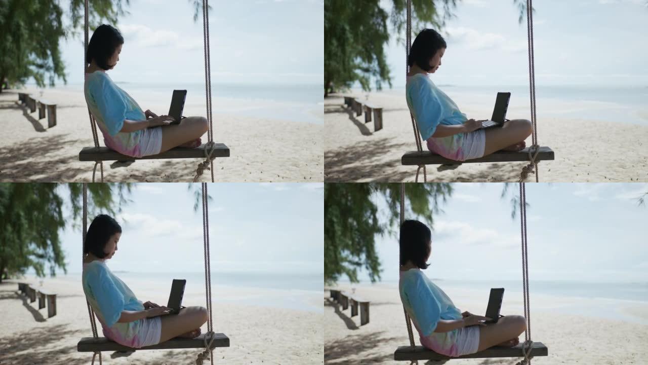 在海滩上使用笔记本电脑的自由职业者