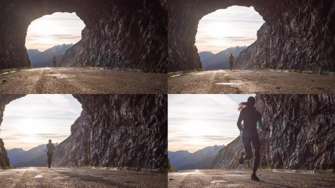 运动活跃的女人穿过山口隧道