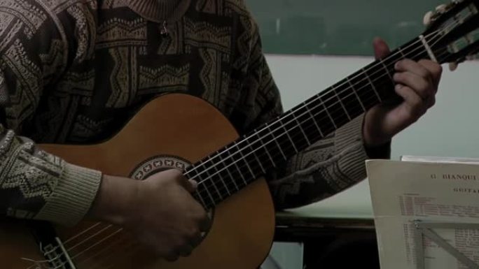 Young Man Playing a Classical Guitar in Class. Clo