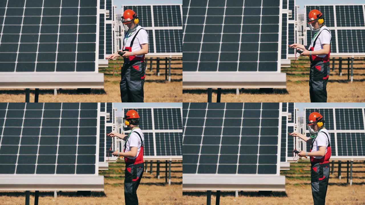 太阳能电池板技术人员使用万用表检查太阳能电池板