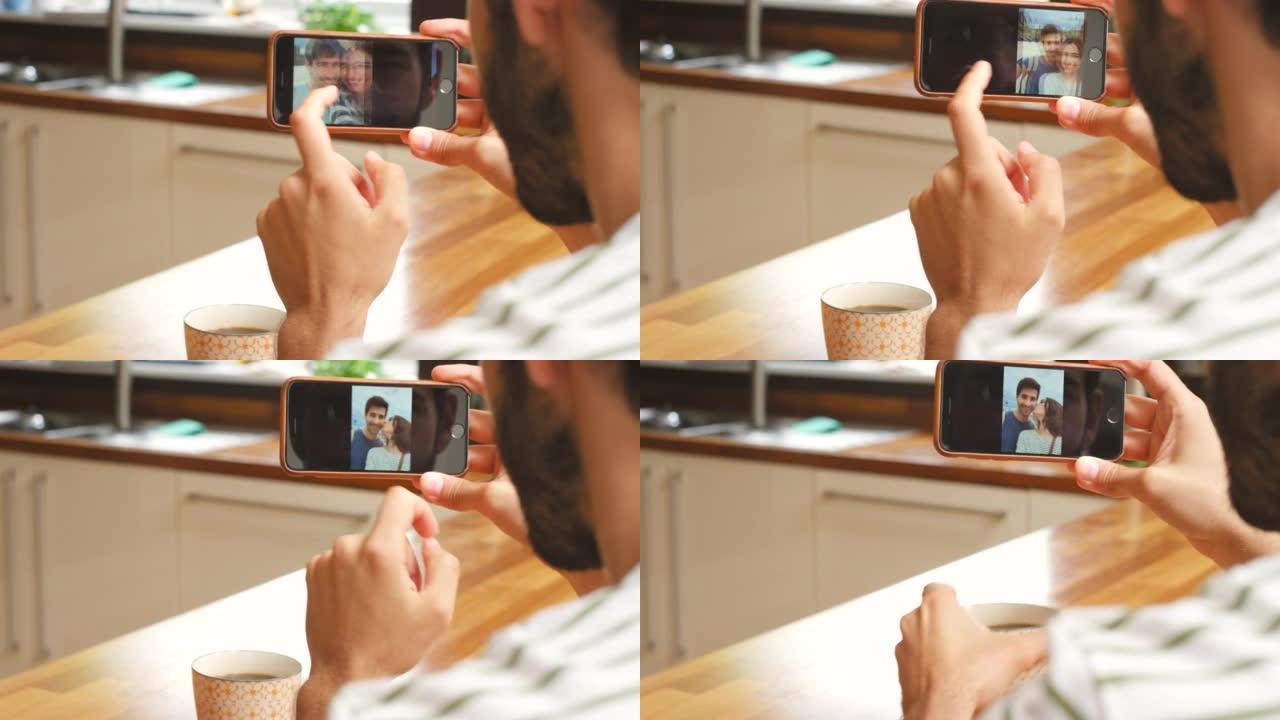 一名男子使用智能手机和一杯热气腾腾的茶的4k视频片段