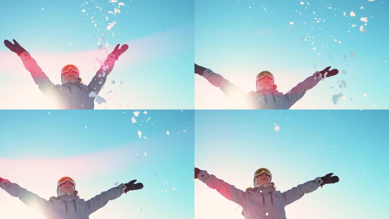复制空间: 开朗的年轻女子在阳光明媚的冬日扔了一把雪。