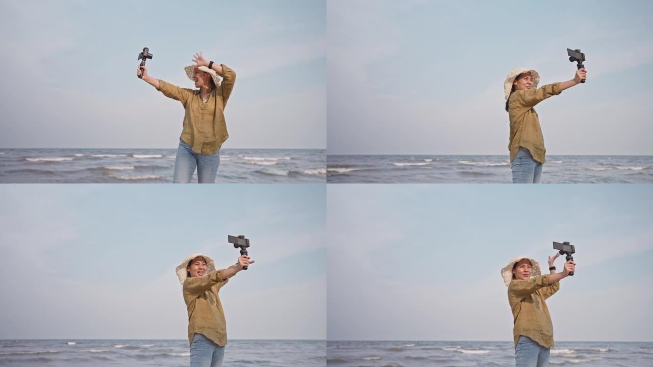 旅行影响者使用相机为她的追随者拍摄海景。