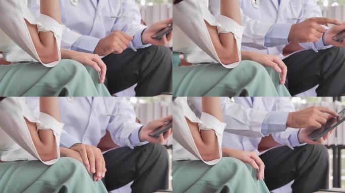 白人男性医生在向她的亚洲年轻女性患者咨询时，牵着她的病人帮助表达同理心，鼓励在医院就诊时进行诊断。男
