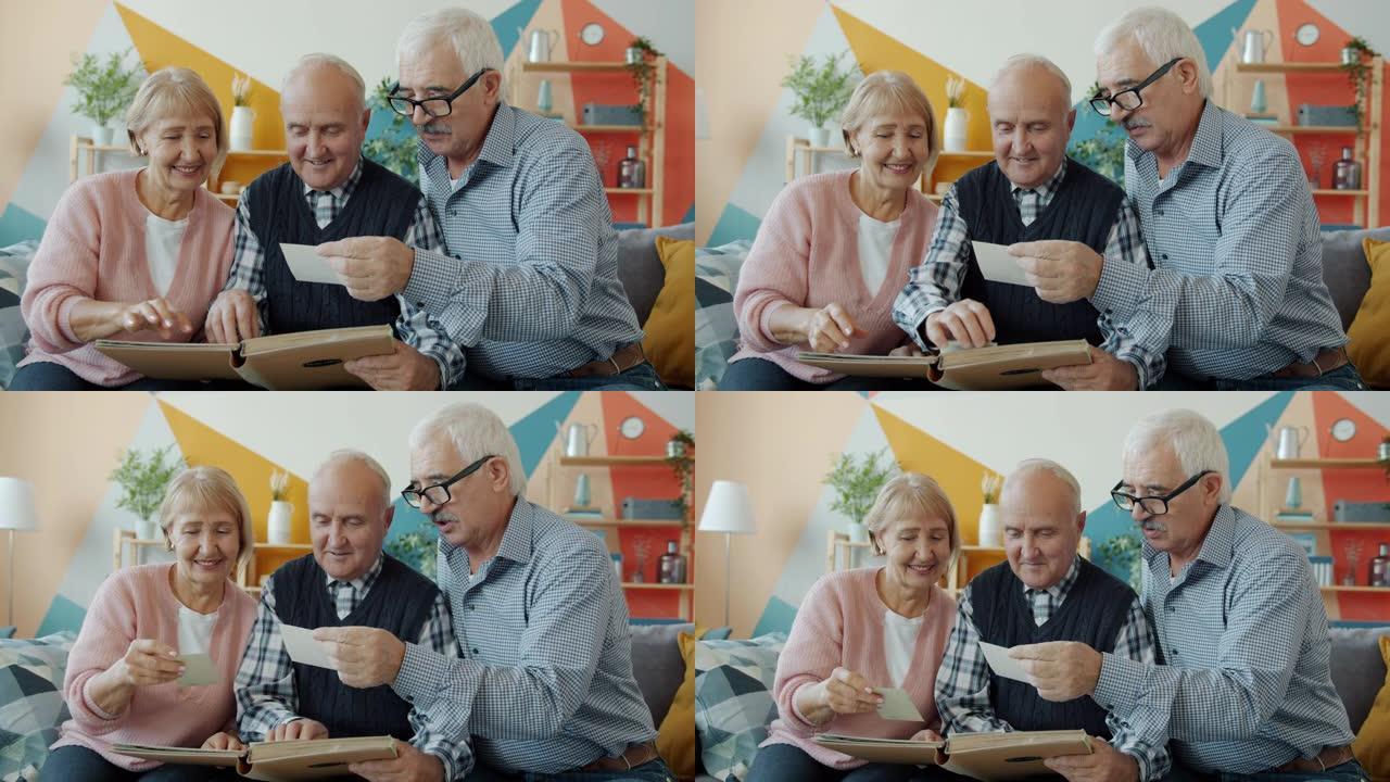 老人和女人在相册中观看照片的慢动作在家里聊天