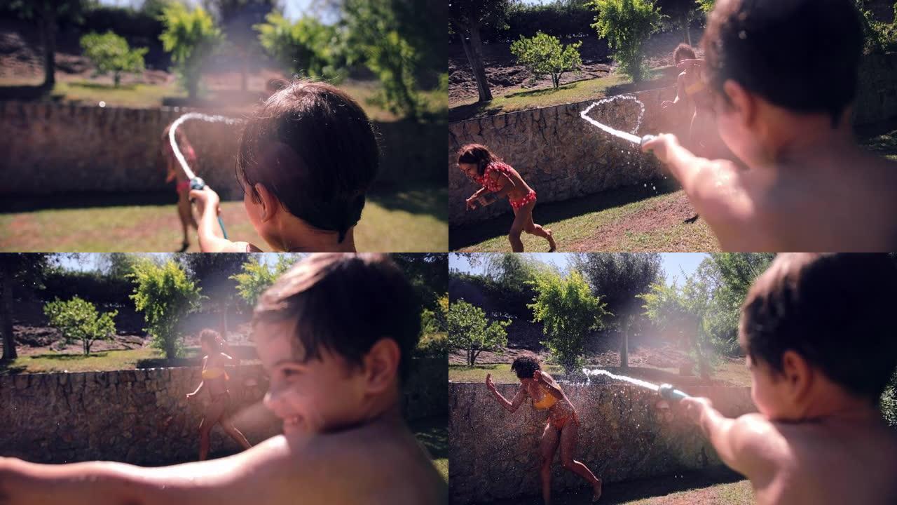 男孩用软管向母亲和其他孩子泼水