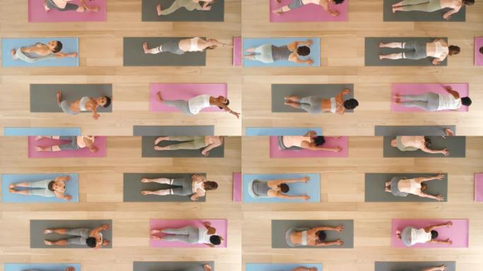 进行瑜伽或普拉提运动，伸展运动或锻炼以促进健康，积极心态和健康的女性类别。放松人群或健身社区训练，以