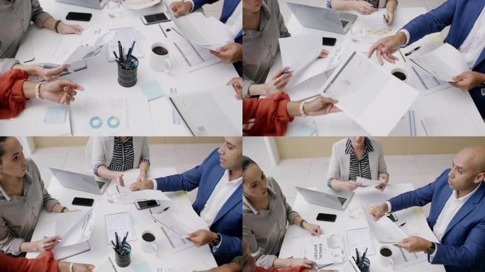 一组商务人士在办公室开会期间审阅文件的4k视频片段