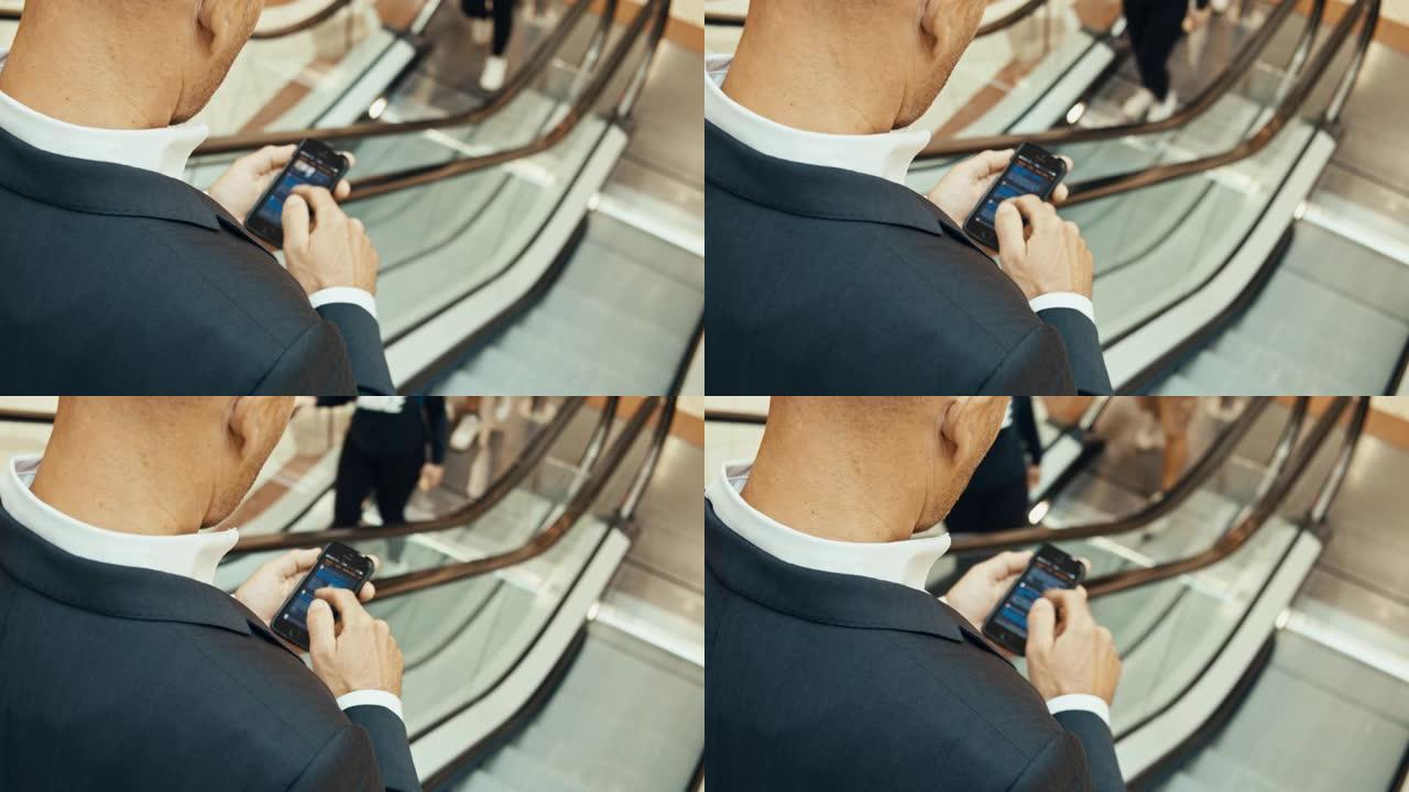 SLO MO无法识别的商人在自动扶梯上使用smarthone
