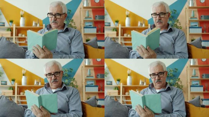 戴着眼镜的聪明老人独自在家躺在沙发上看书