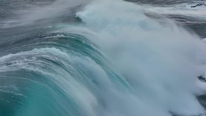 强波撞击的慢动作航拍。海洋或海洋大暴风雨冲浪清澈的绿松石水，泡沫白色纹理