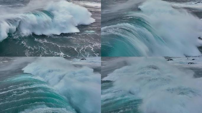 强波撞击的慢动作航拍。海洋或海洋大暴风雨冲浪清澈的绿松石水，泡沫白色纹理