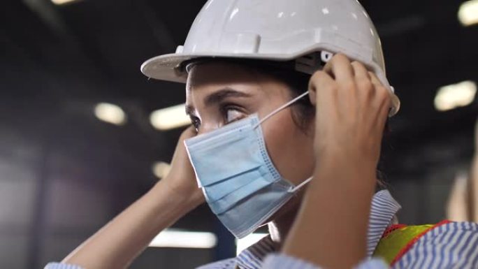 戴着防护面罩的女工程师面部和安全帽: 智能行业工人操作的概念