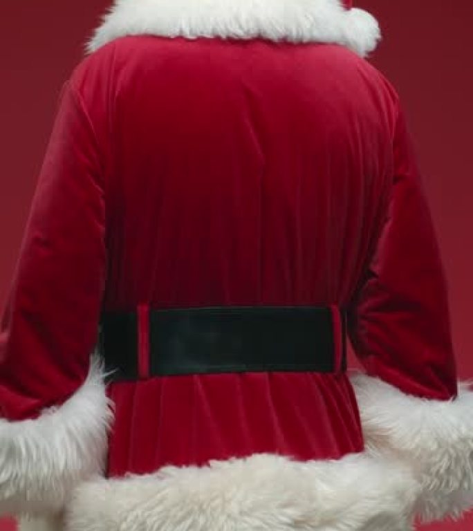 在红色背景上翻动圣诞老人的垂直视频，微笑着在视频结尾竖起大拇指