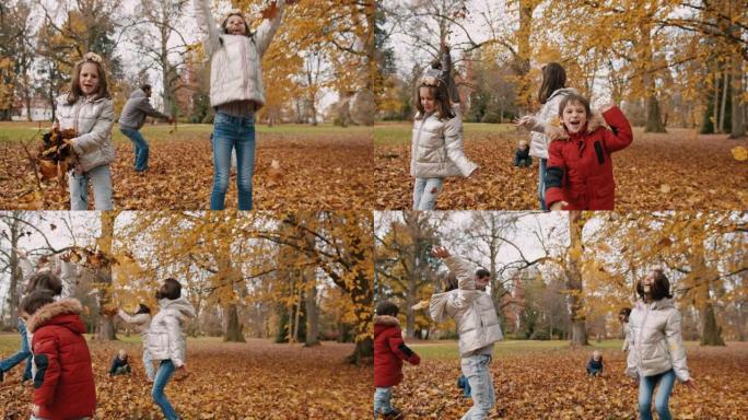 有孩子在公园玩秋叶的父母