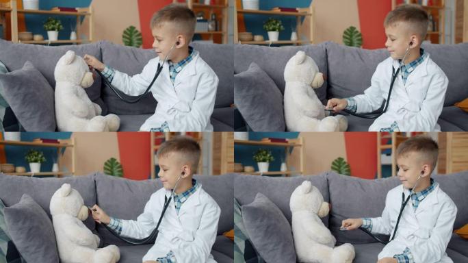 有趣的孩子玩泰迪熊用听诊器检查玩具独自享受游戏