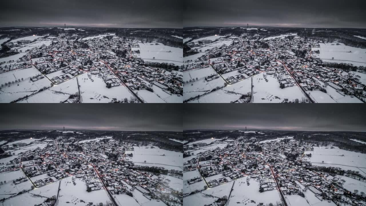 积雪落在被冬季景观包围的德国村庄前-鸟瞰图