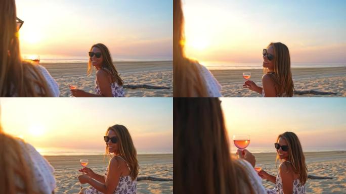 WS两个女人在日落时在沙滩上喝玫瑰酒很有趣