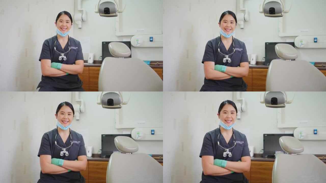 一位自信的牙医在医疗诊所双臂交叉的肖像。亚洲专业正畸医生等待患者检查牙齿卫生常规，填充物和牙龈疾病