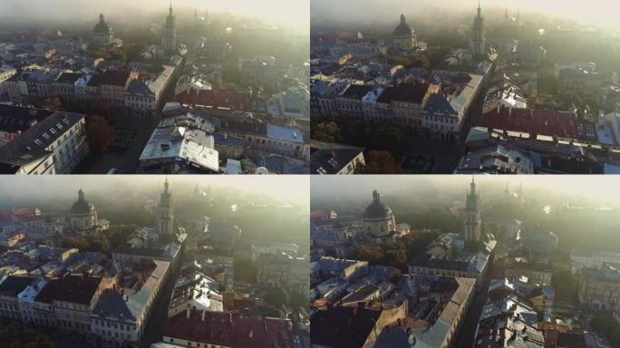 乌克兰利沃夫老城市中心的空中拍摄。轻雾笼罩着利沃夫市的教堂和大教堂。冉冉升起的阳光中五颜六色的老房子