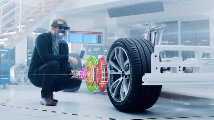 在电动汽车底盘平台上工作的汽车工程师，使用带有3D VFX软件的增强现实耳机在概念运输车上开发再生制