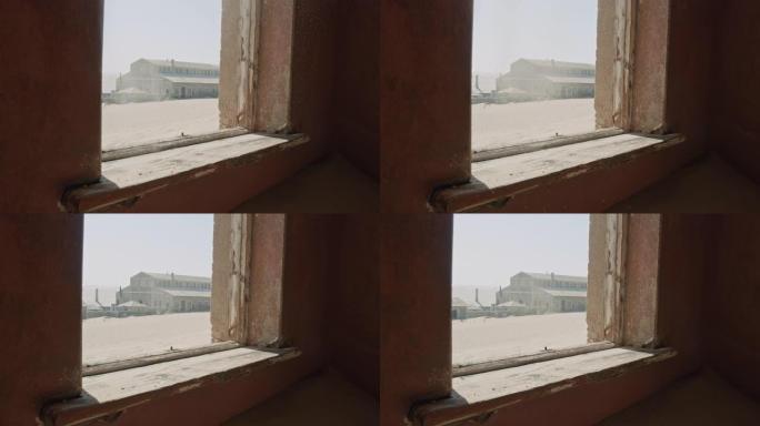 从废弃建筑的窗户吹出沙漠沙子的MS视图，纳米比亚，非洲