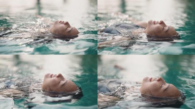 年轻女子漂浮放松年轻女子漂浮放松游泳仰泳
