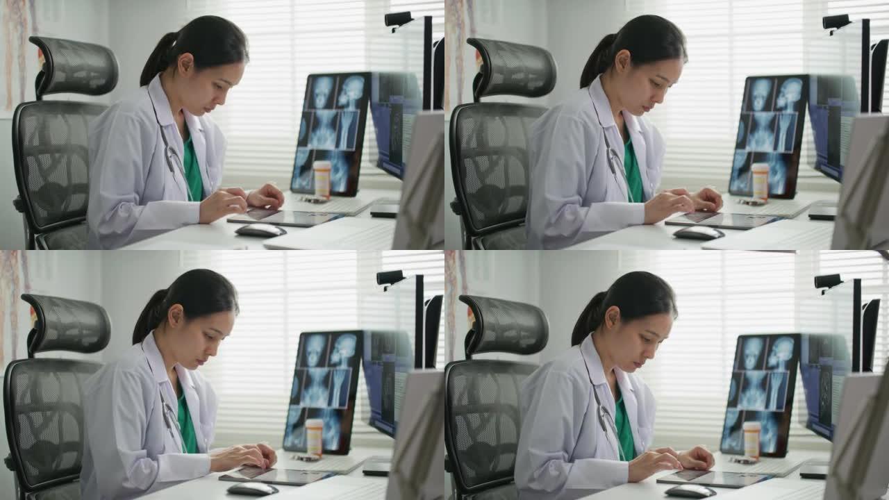 医生在办公桌上在数字平板电脑上输入Rx处方