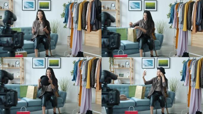 时尚的亚洲女性视频记录器在家使用相机制作服装视频