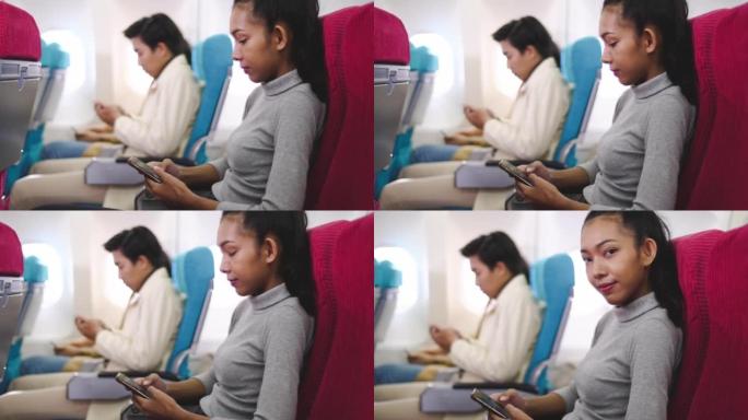 在飞机上使用电话国际航班起飞前黑人女子