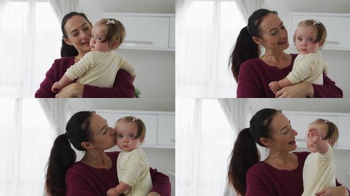 白人母亲在家中抱着婴儿玩耍和亲吻