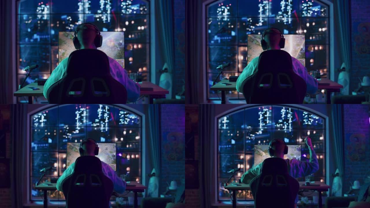 在家里霓虹灯照明的客厅中，在个人计算机上的视频游戏中获胜的成功玩家的头部后角。阁楼公寓舒适的夜晚。