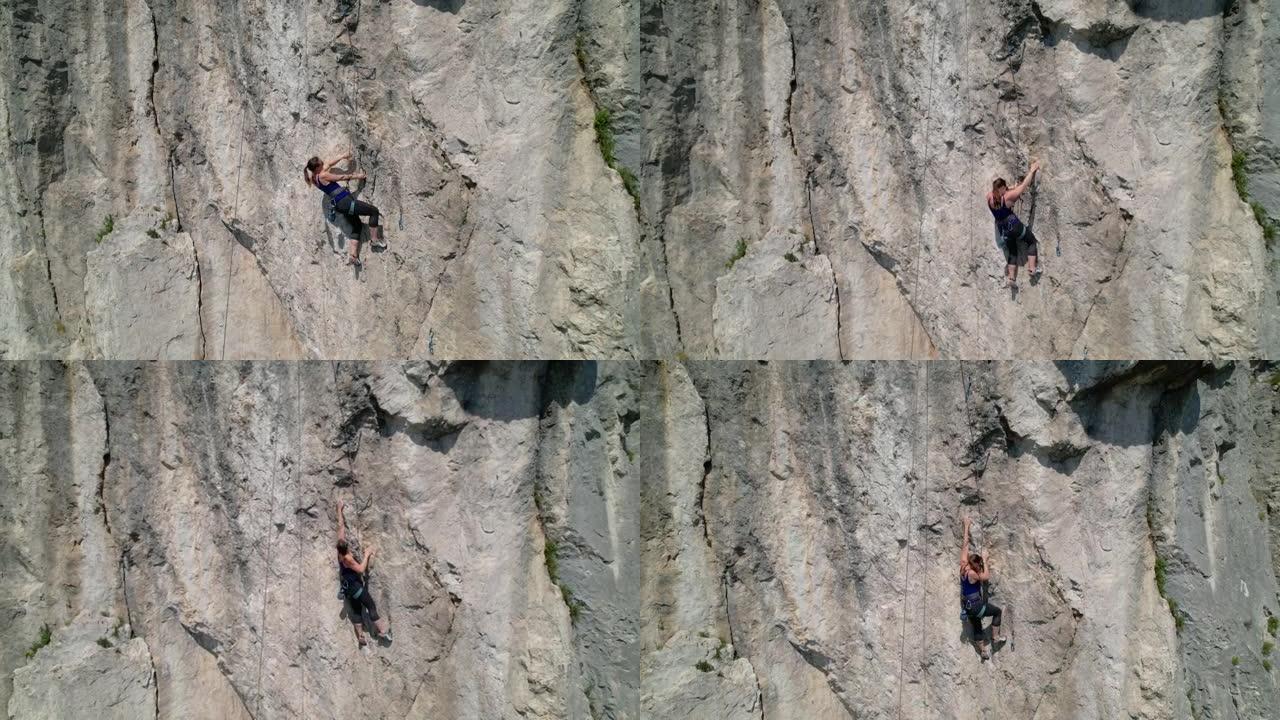 空中: 一名运动女性学习攀爬绳索的无人机观点。