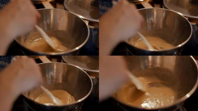 厨师在厨房中通过双重锅炉方法准备酱汁或糖霜