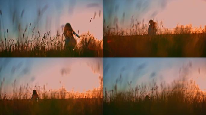 日落时分，SLO MO无法识别的小女孩在草地上奔跑