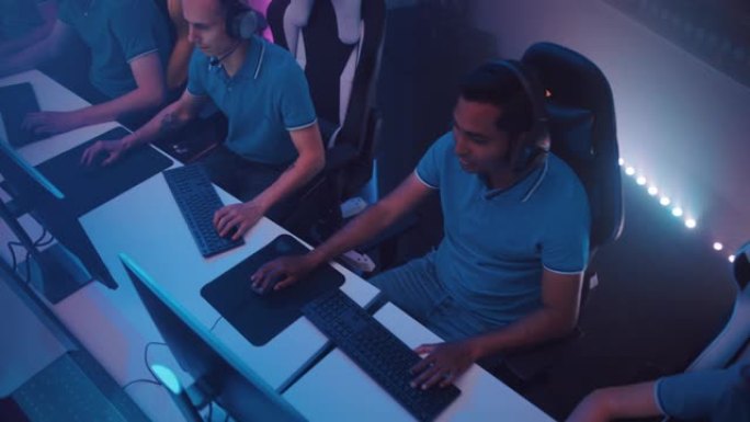 专业游戏玩家组成的多元化eSport团队在锦标赛上参加计算机视频游戏的比赛。时尚霓虹灯网络游戏在线流