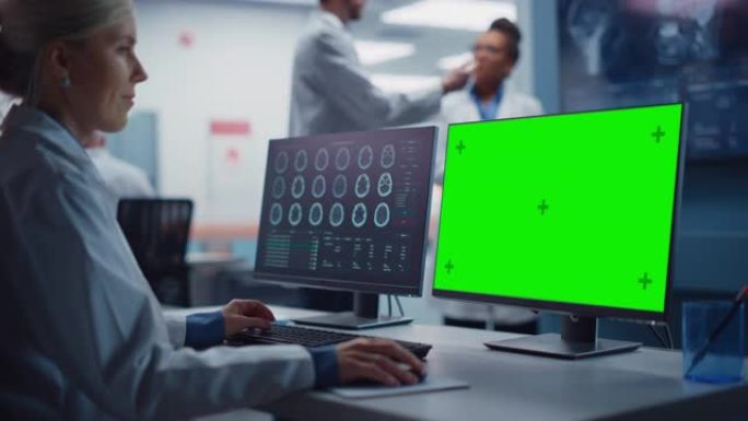 医院研究实验室: 女性医学生物技术科学家，在绿屏色度键计算机上进行脑部扫描MRI图像。背景: 神经科