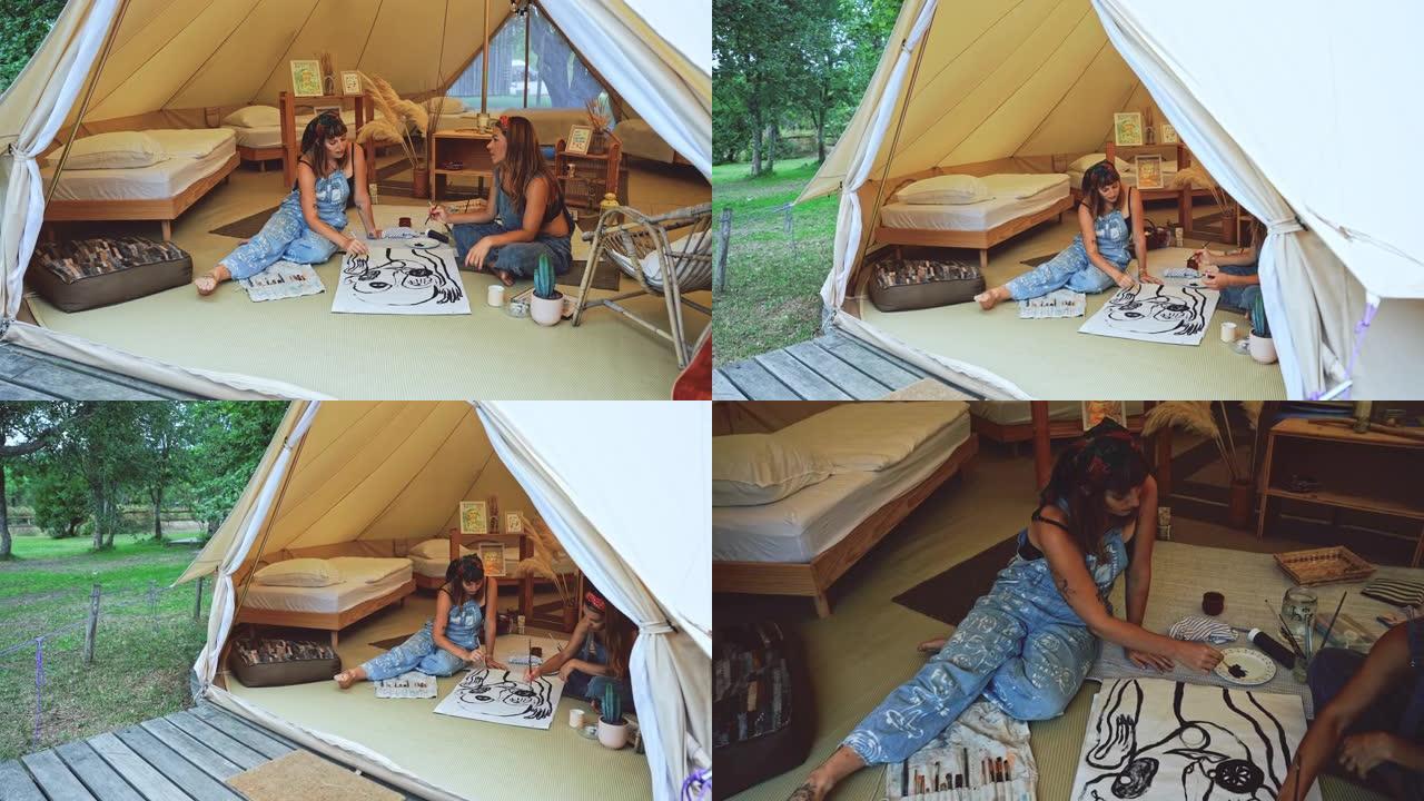 SLO MO两个年轻女子在帐篷里画画时交谈