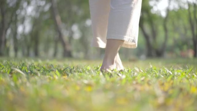 女人腿部行走在大自然中冥想瑜伽的特写