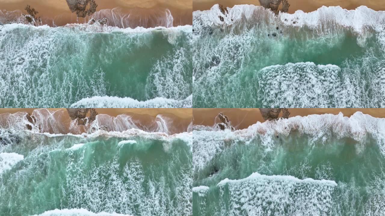 海岸线波浪飞溅在岩石上的鸟瞰图