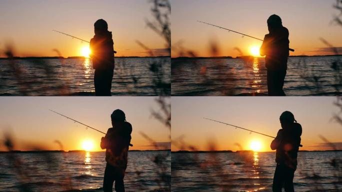 小男孩在日落时将钓鱼竿扔进湖中