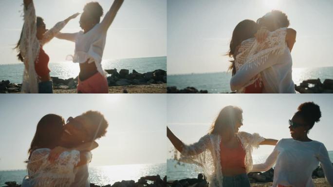 年轻快乐的多民族女友的慢动作在阳光明媚的日子里，在大海的海滩上拥抱。