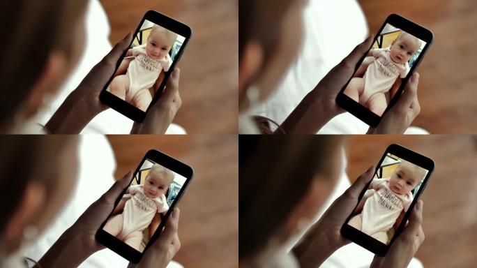 母亲在家中通过视频通话在智能手机上与婴儿交谈