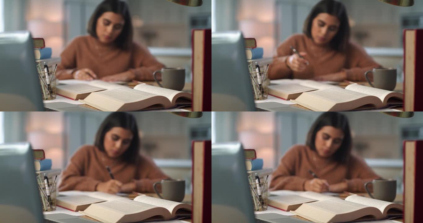 4k视频片段，一个迷人的年轻女子独自坐在家里，在学习时在书中写笔记