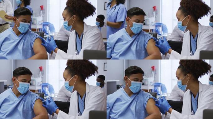 混血女医生在医院给男同事接种covid疫苗，都戴着口罩