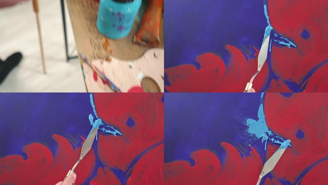 艺术家画家用调色板刀在画布上绘画。