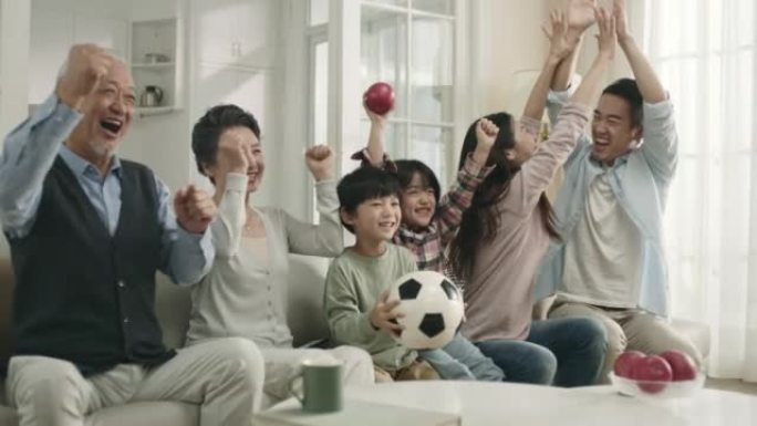 亚洲三代家庭在家收看电视直播球赛